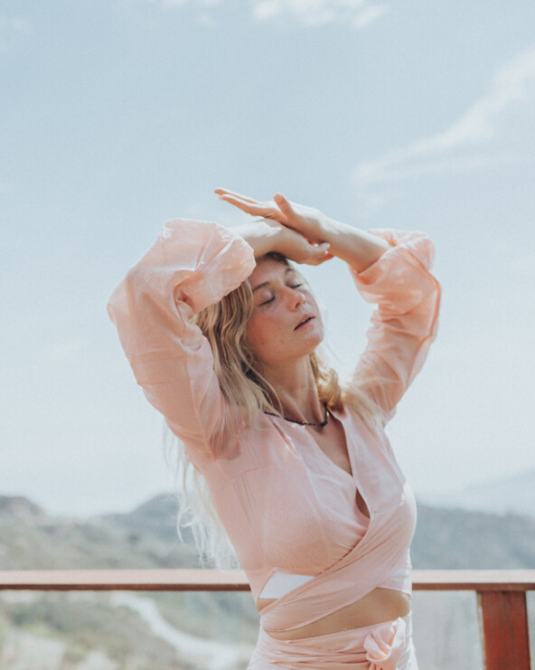 blonde woman basking eyes closed in the sun in Malibu