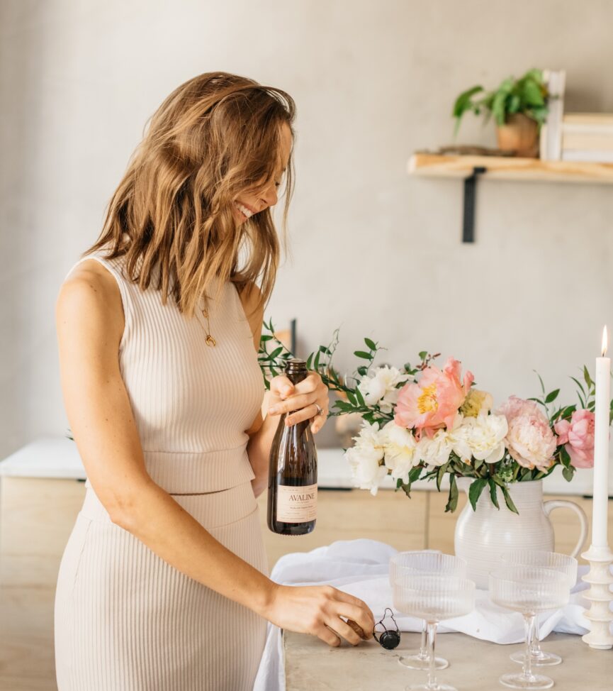 Camille Styles pouring wine.