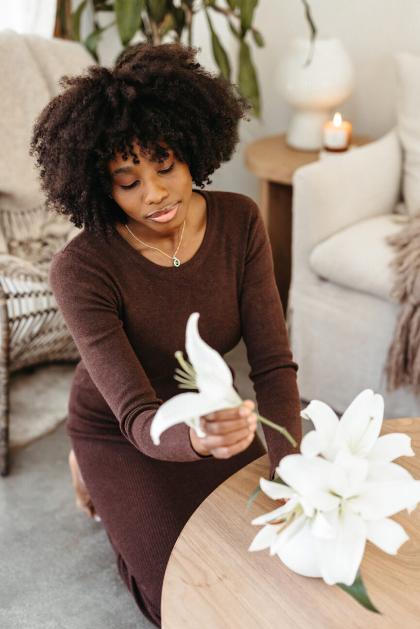 Woman arranging flowers.