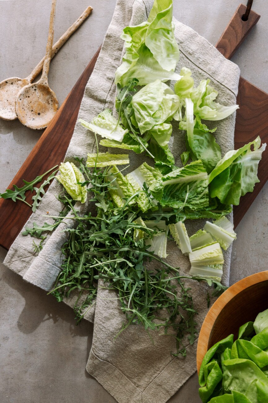 washing lettuce and arugula, fresh spring produce, greens, meal prep, kitchen, casa zuma gathering board