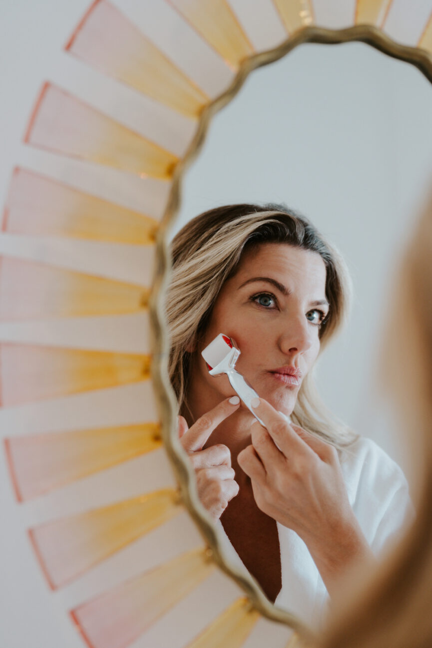 Woman doing facial rolling. 