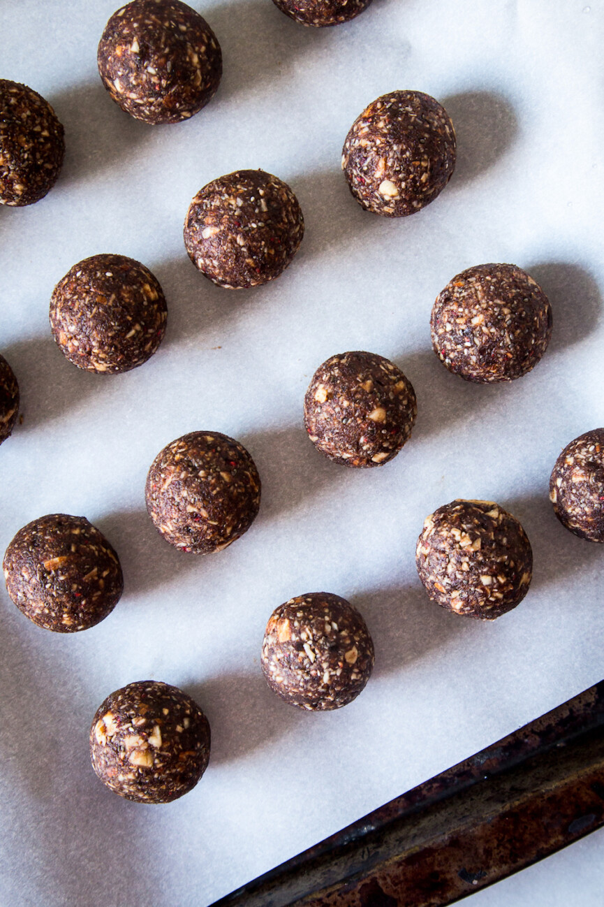 raspberry cocoa energy balls on baking sheet