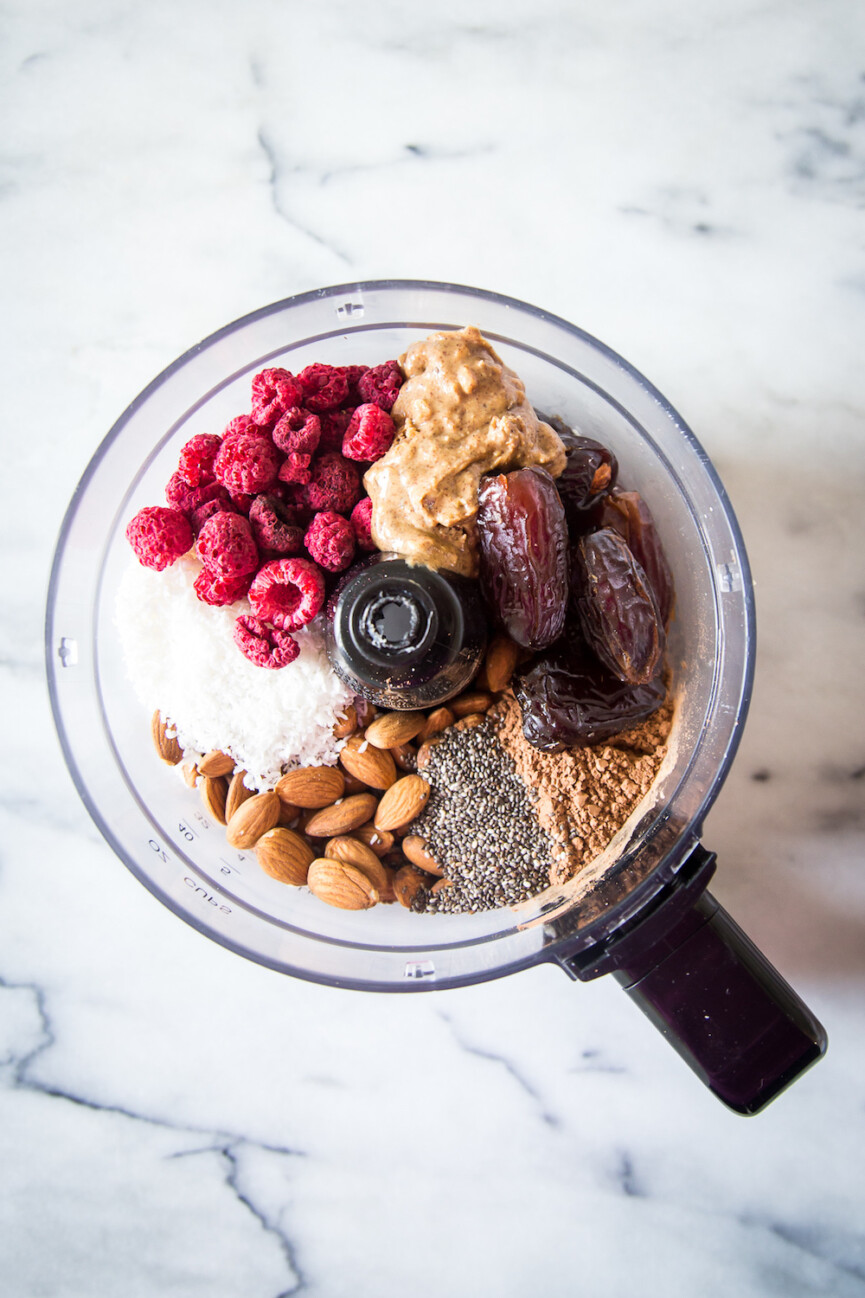 Raspberry cocoa no bake energy bites in food processor.