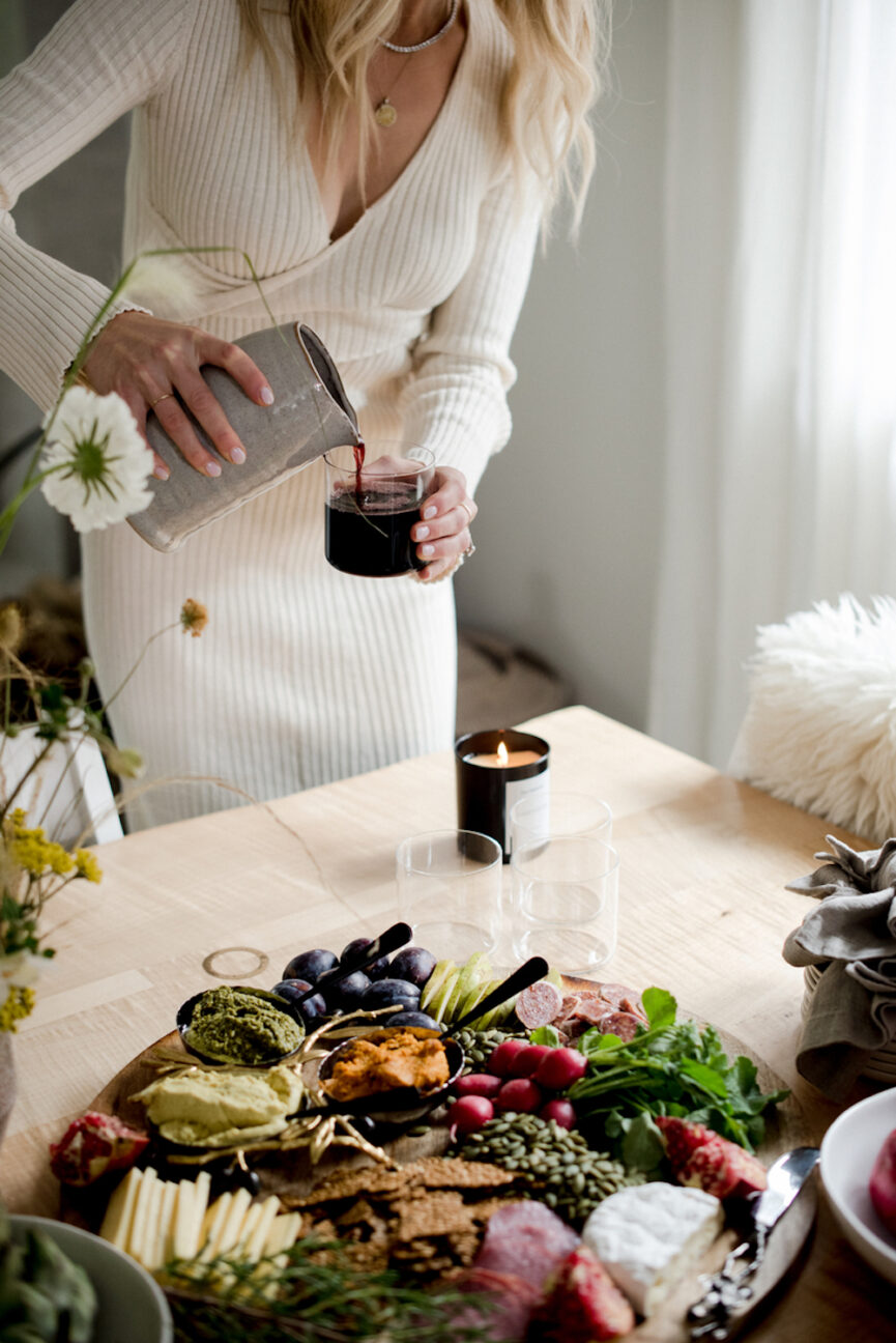 Woman pouring red wine.