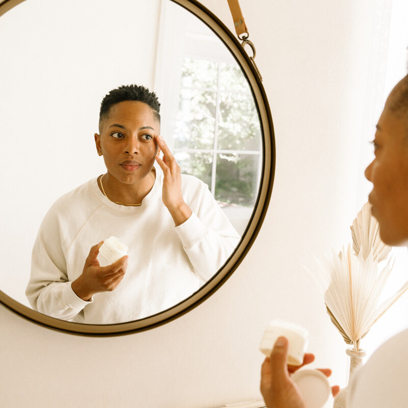 Woman applying skincare around her eyes - riley blanks photography