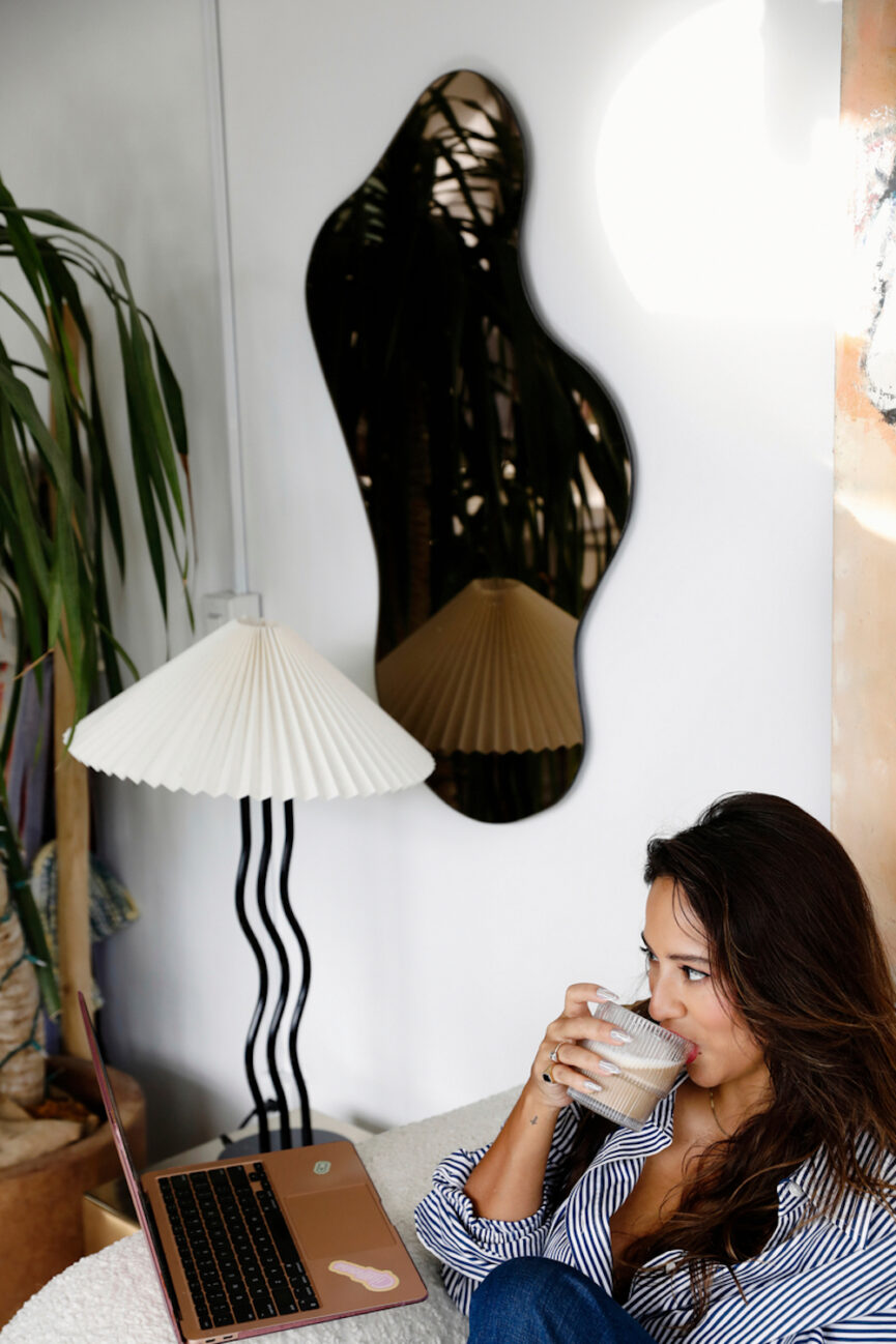 Woman drinking coffee on couch.