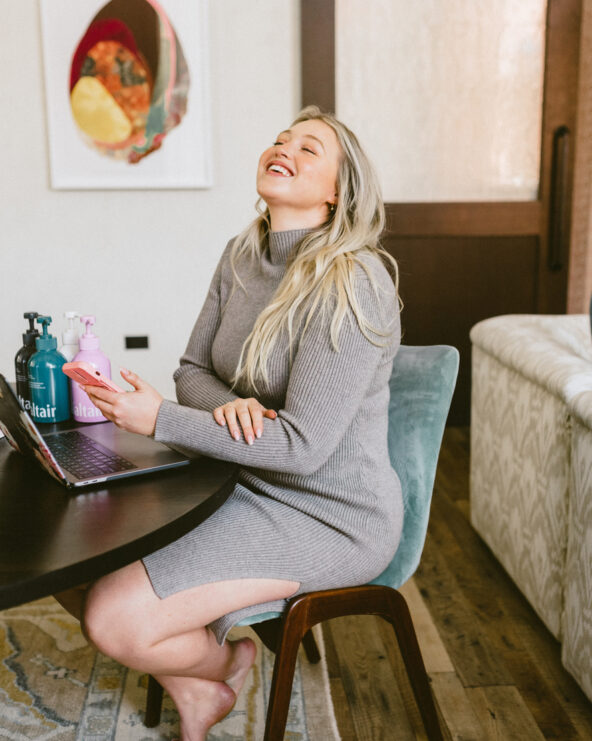 Woman laughing in comfortable work from home outfit.