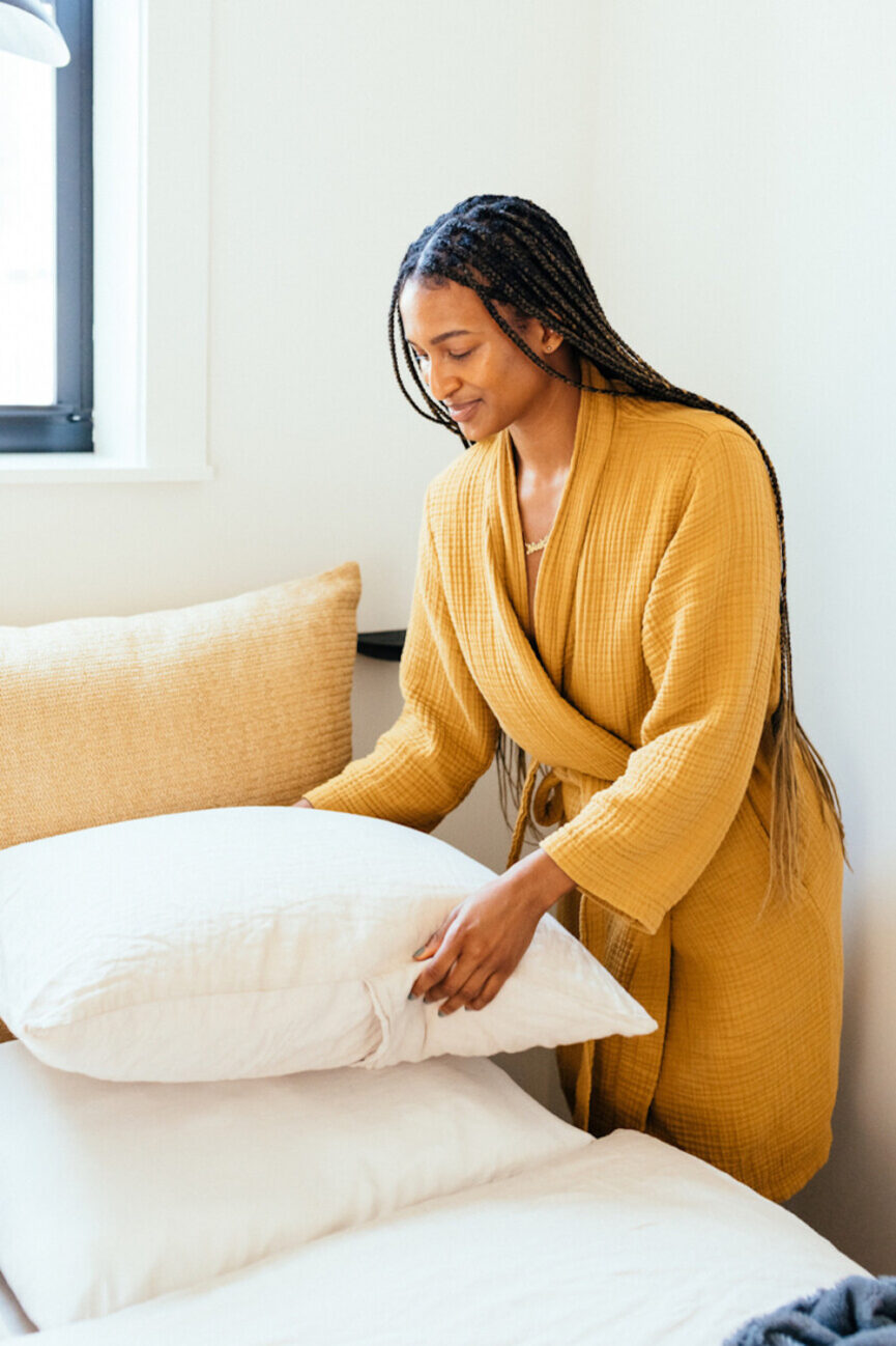 Woman making bed.